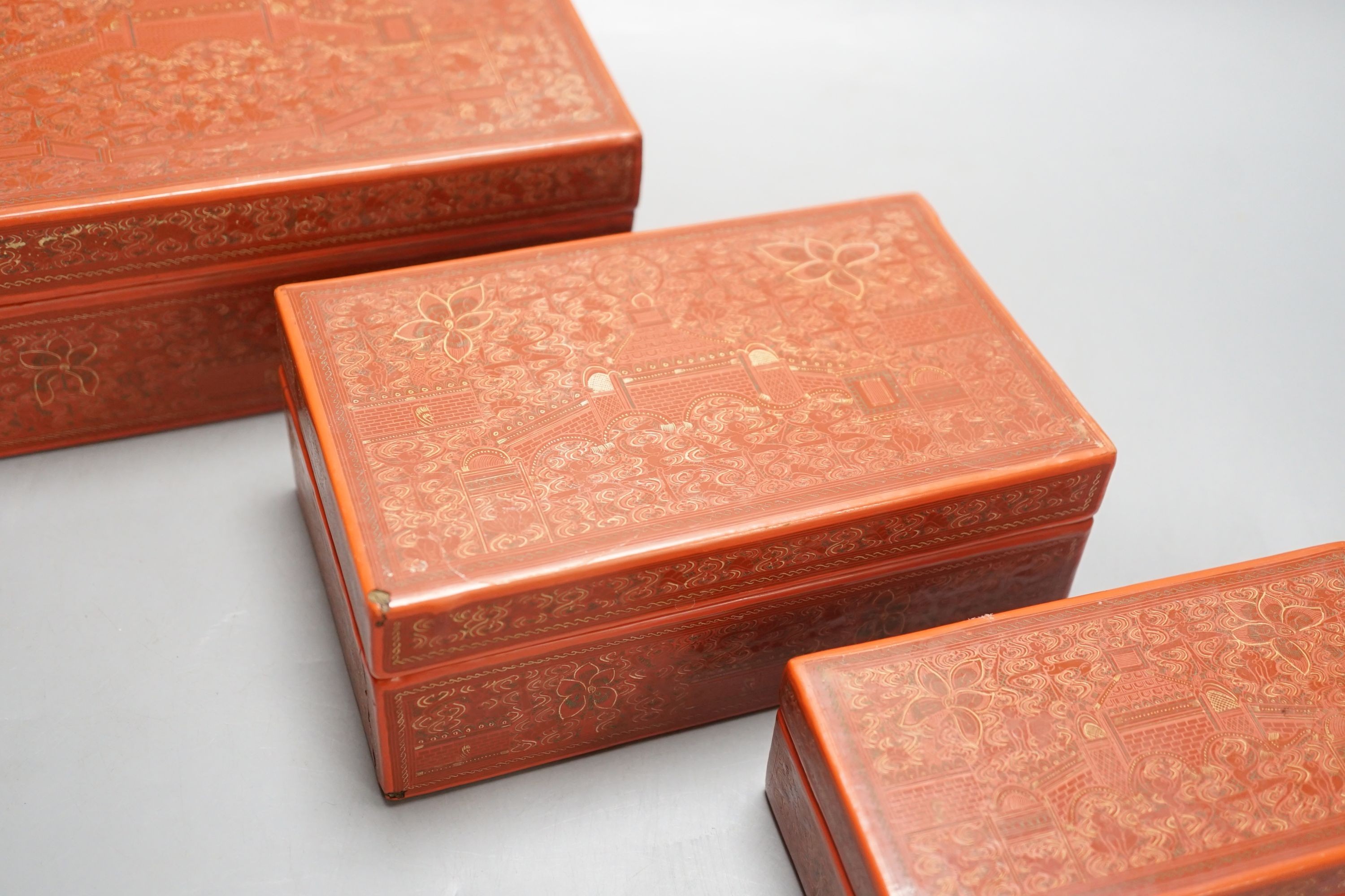 Three Burmese red lacquer graduated boxes, largest 21 cms wide.